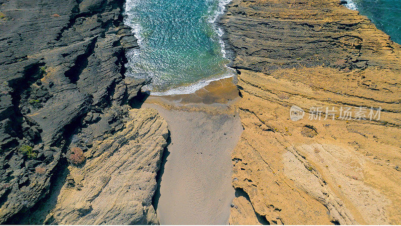 Aerial view of the hidden cove beach "Playa Cumplida" at the natural reserve of "Montaña Pelada" in Tenerife (Canary Islands). Drone shot